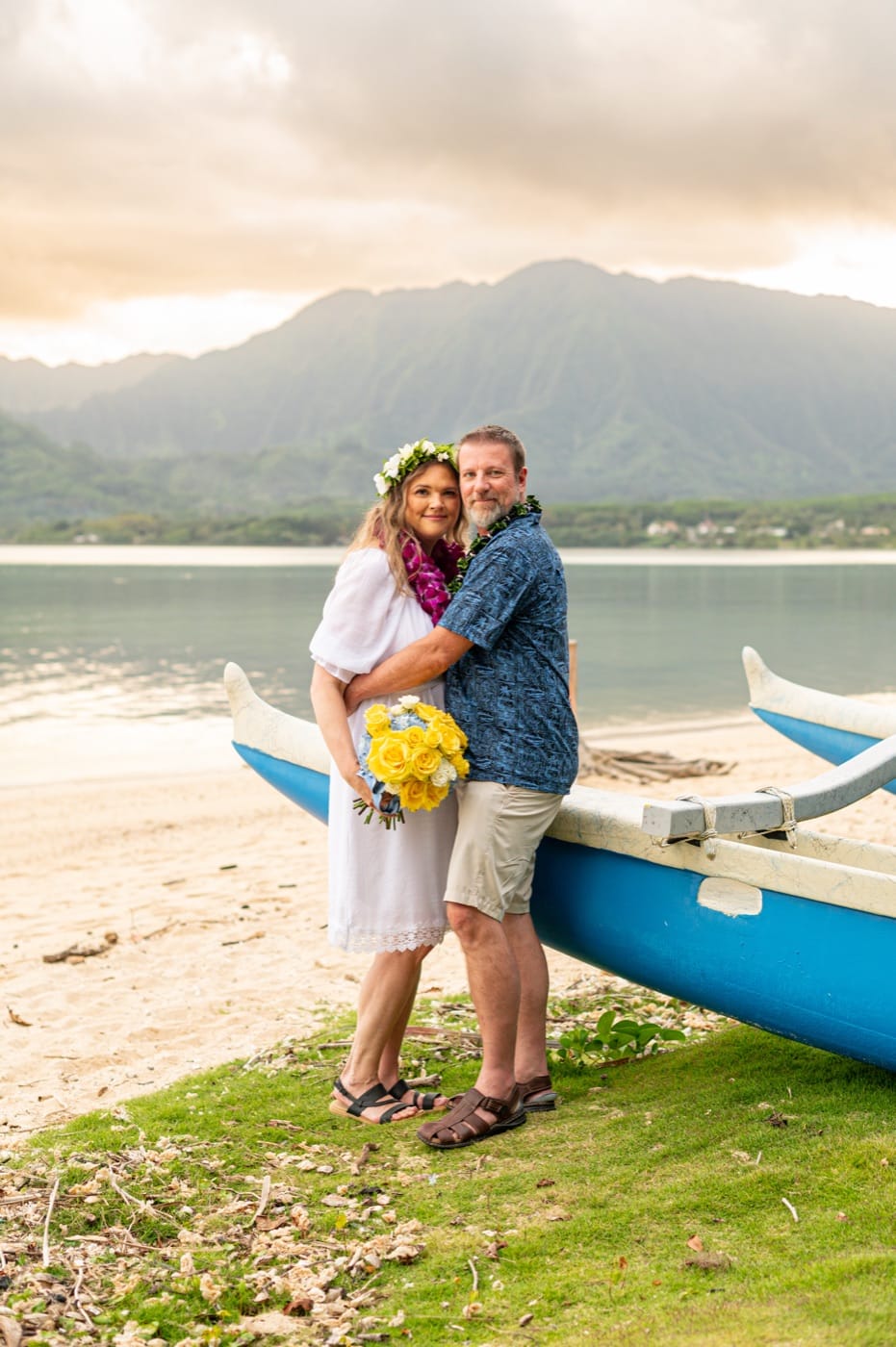 A couple on the beach at Kualoa, the mountains behind
