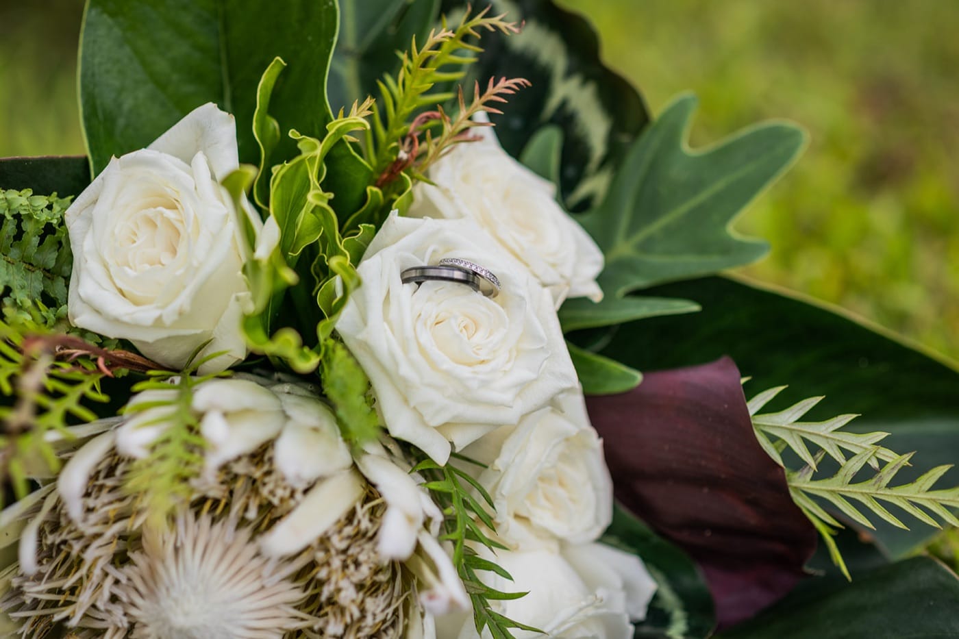 The bouquet and the rings, white roses and greenery, on an Oahu elopement day